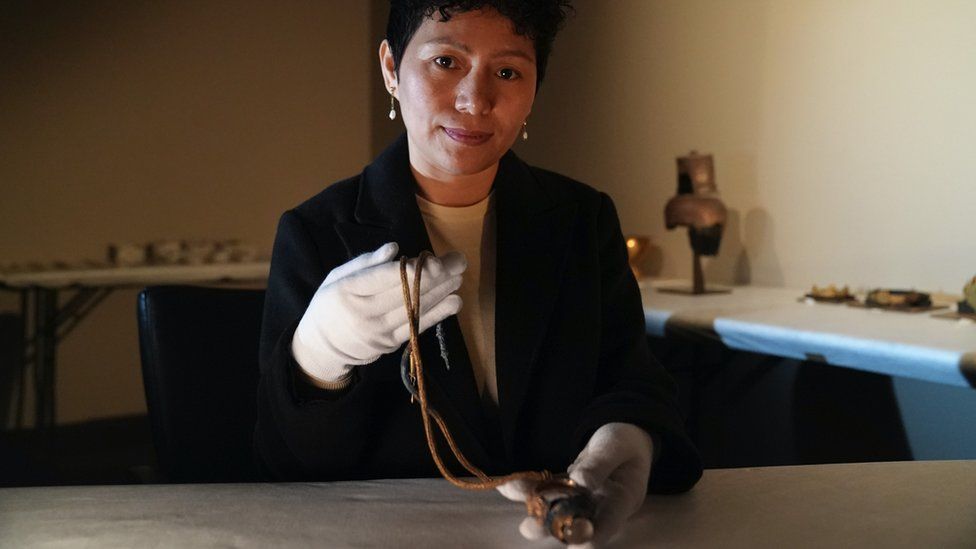 Sonetra Seng holding a piece of jewellery