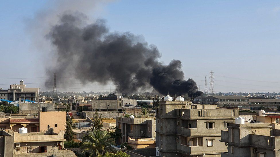 Smoke plumes coming out of buildings following airstrikes on Tajoura, south of Tripoli, on 29 June