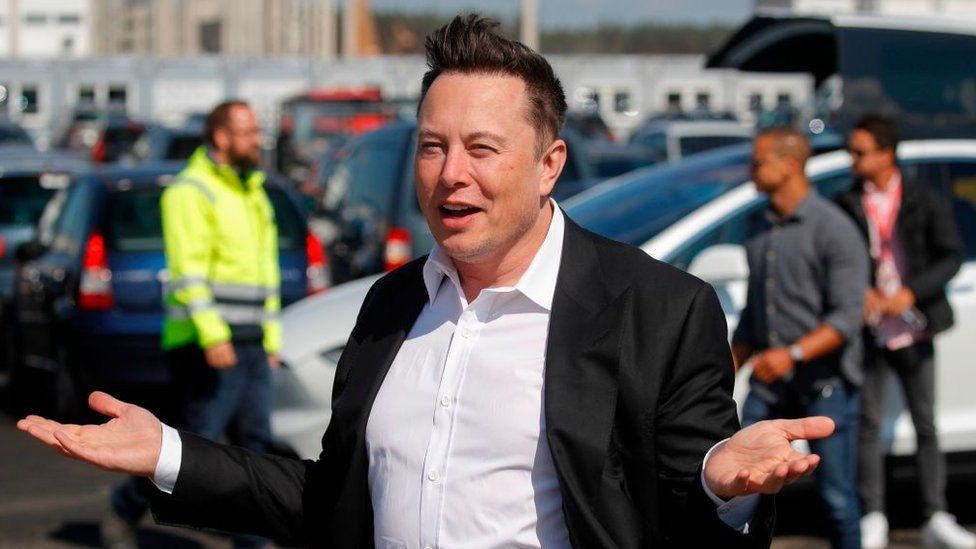 Elon Musk with palms outstretched