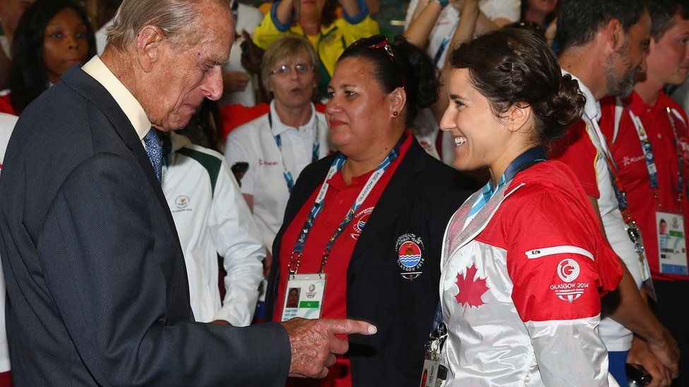 Prince Phillip is greeted by Canadian athlete Isabelle Després during a visit to the Athletes' Village during the Commonwealth games in Glasgow in July 2014