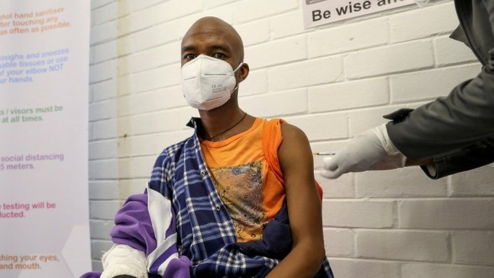 A South African man is given a dose of an experimental vaccine