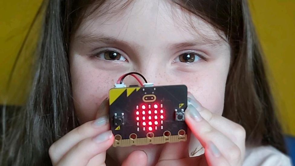 A young girl holds the Micro Bit