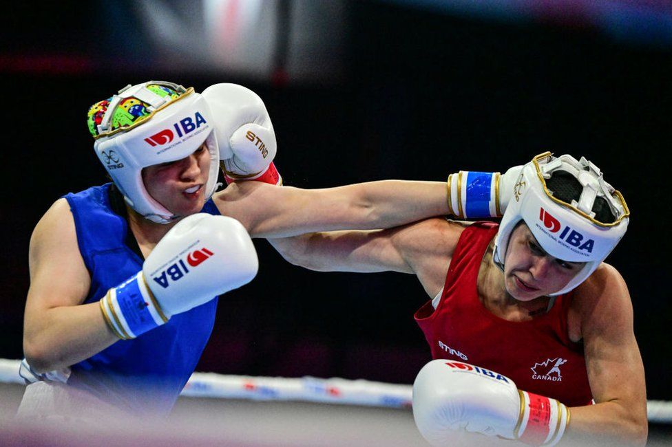Charlie Cavanagh (red) of Canada competes with Ichrak Chaib (blue) of Algeria in the 66 kg match of the International Boxing Association (IBA) Women's World Boxing Championships in Istanbul, Turkiye on May 18, 2022