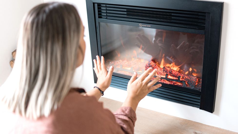 Woman in front of gas fire