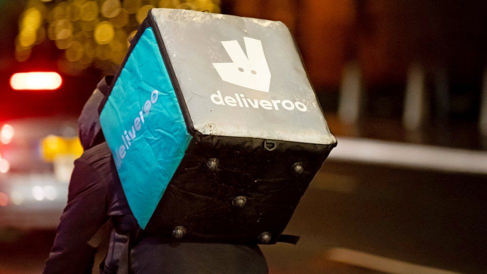 A Deliveroo rider at work at night on December 22, 2018 in Cardiff,
