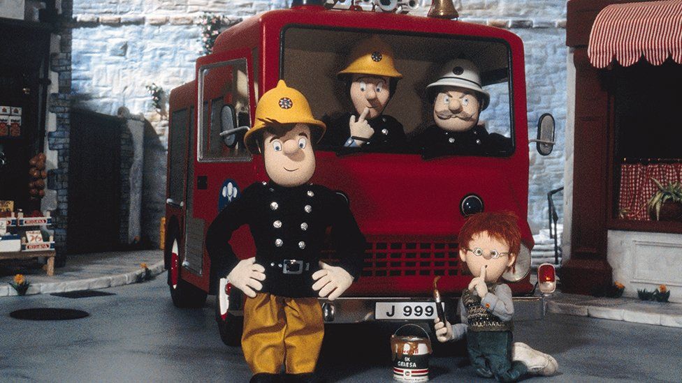 Fireman Sam, Elvis Cridlington, station officer Steele and 'naughty' Norman Price with Jupiter the fire engine in Pontypandy