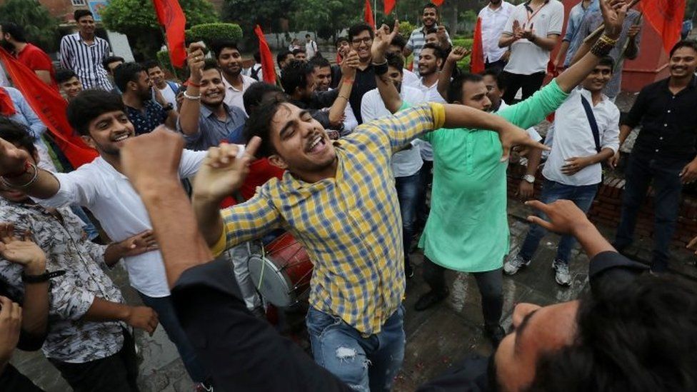 Activists from the Akhil Bharatiya Vidyarthi Parishad (ABVP), the student wing of Indiaâ€™s ruling Bharatiya Janata Party (BJP), celebrate after the government scrapped the special status for Kashmir, in New Delhi, India, August 5, 2019.