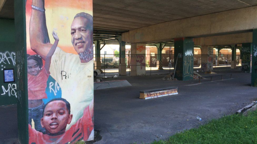 A faded mural of Bill Cosby still stands near the Richard Allen homes in North Philadelphia.