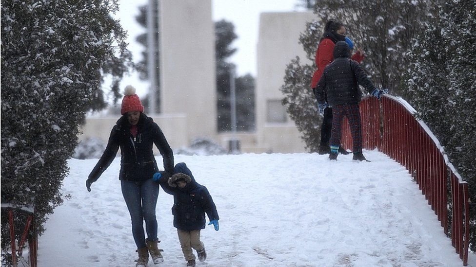 People have fun in the snow, in Ciudad Juarez, in the state of Chihuahua, Mexico, 14 February 2021