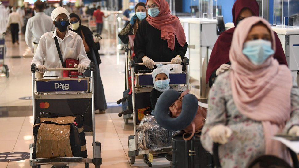 Indian nationals wait to board a repatriation flight at Dubai's international airport on 7 May 2020