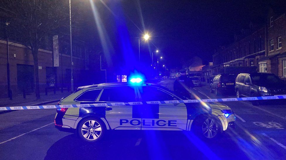 A police car behind a cordon