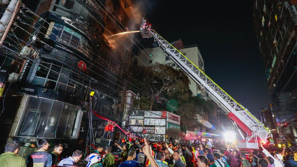 Bangladeshi firefighters try to douse the fire after flames erupted at a building in Dhaka, Bangladesh, late 29 February 2024.