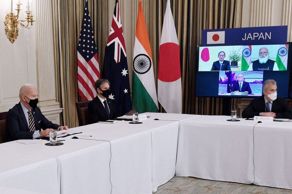 US President Joe Biden (L), with Secretary of State Antony Blinken (2nd L), meets virtually with members of the "Quad" alliance of Australia, India, Japan and the US, in the State Dining Room of the White House in Washington, DC, on March 12, 2021.