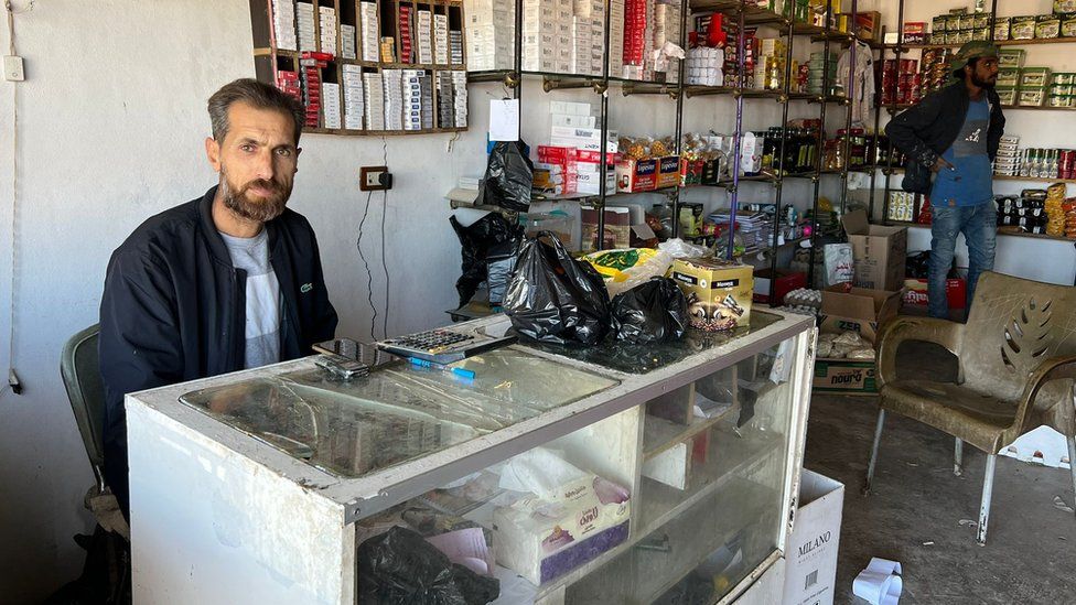Randil behind the counter in his shop