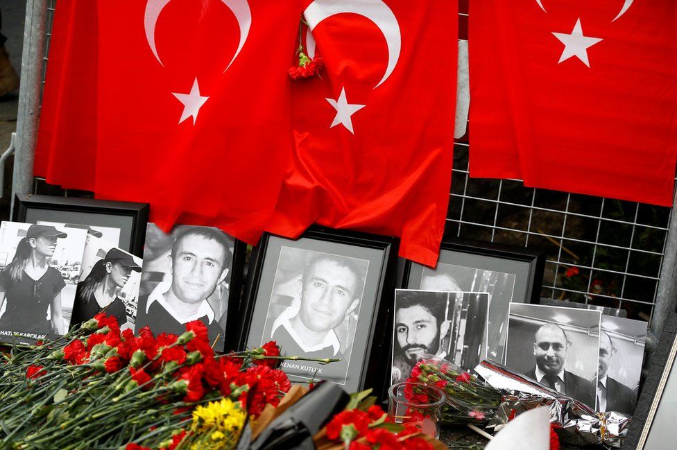 Flowers and pictures of the victims are placed near the entrance of Reina nightclub