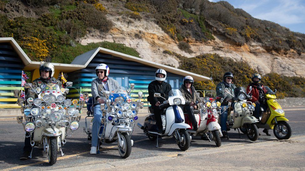 Members of a local scooter club on the seafront on Boscombe beach