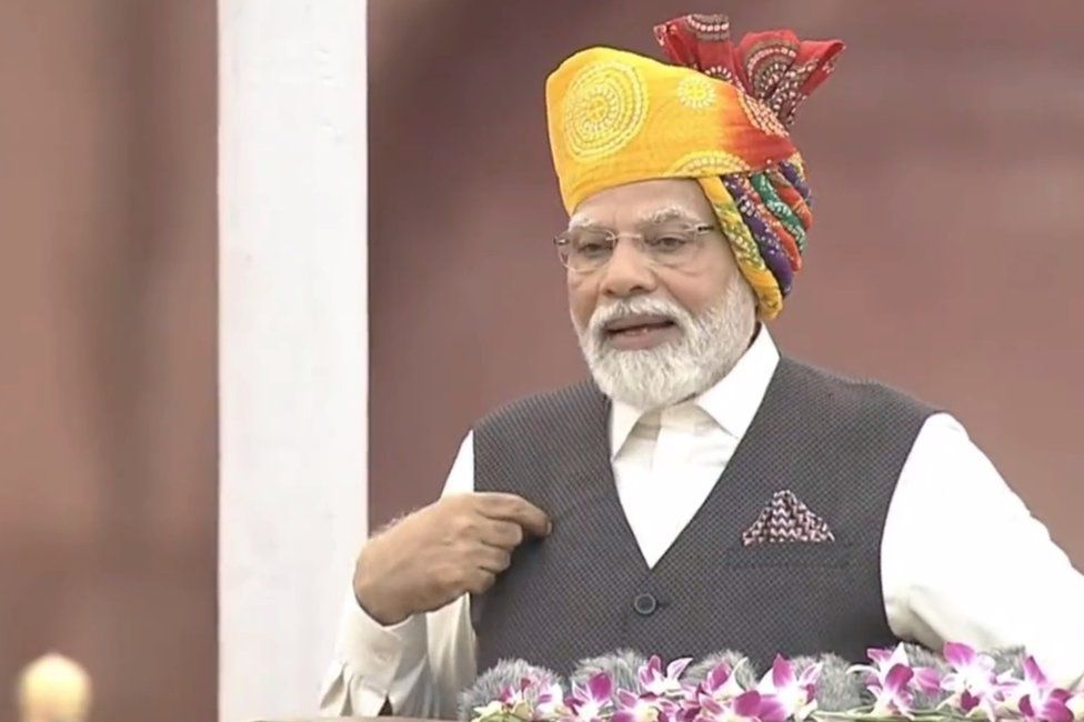 Narendra Modi in a yellow-red turban