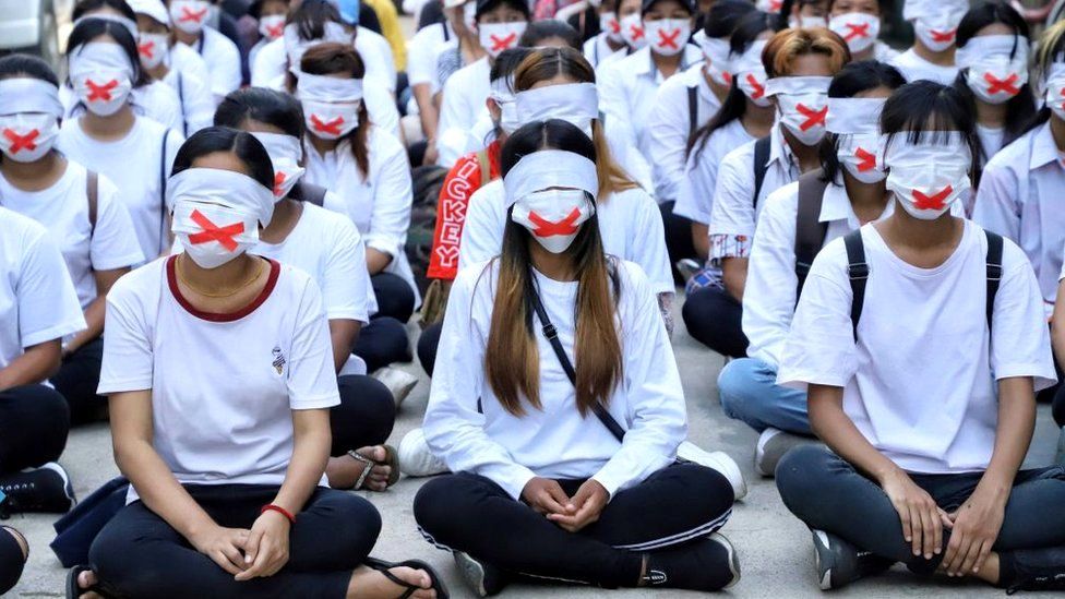 Protesters with cover their mouths and eyes in a "silent strike" on 24 March 2021, to protest the military shooting dead a sevem-year-old girl