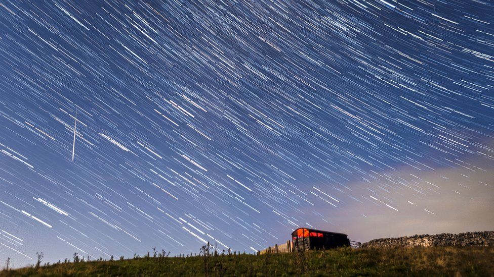 Digital composite of 30 photographs taken implicit    a play  of 15 minutes successful  2017. Meteors and prima  trails during the Perseid meteor ablution  seen from adjacent   Hawes successful  the Yorkshire Dales National Park, arsenic  the Earth flies done  a unreality  of cometary particulate  creating a spectacular show  of celestial fireworks.