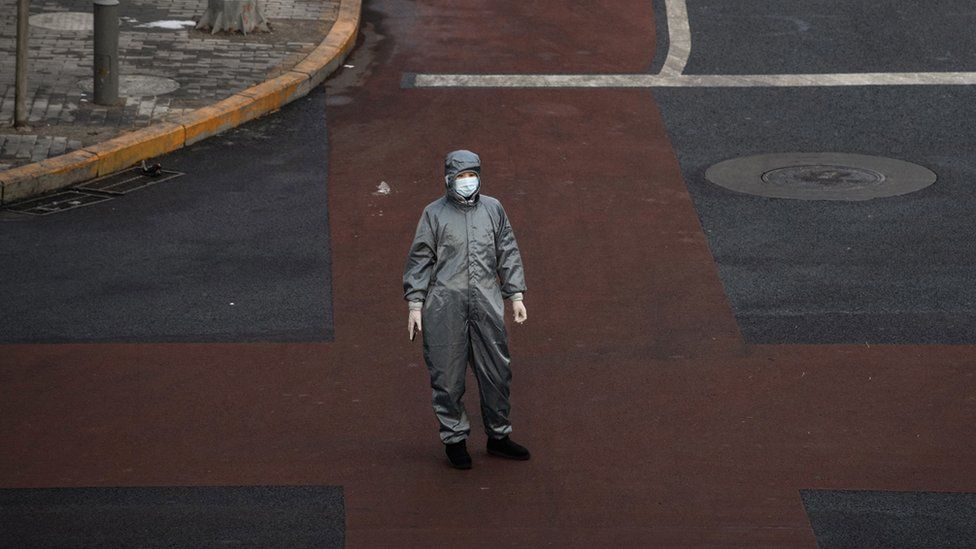A Chinese woman wears a protective suit in Beijing