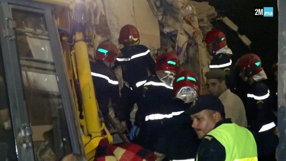 Civil protection members search for survivors near rubble in Chichaoua