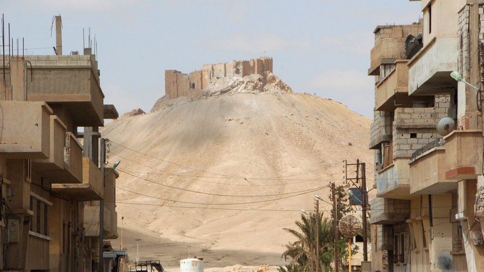A picture taken on March 27, 2016, shows the citadel of the ancient city of Palmyra as seen from a residential neighbourhood of the modern town after Syrian troops recaptured the city from the Islamic State (IS) group.