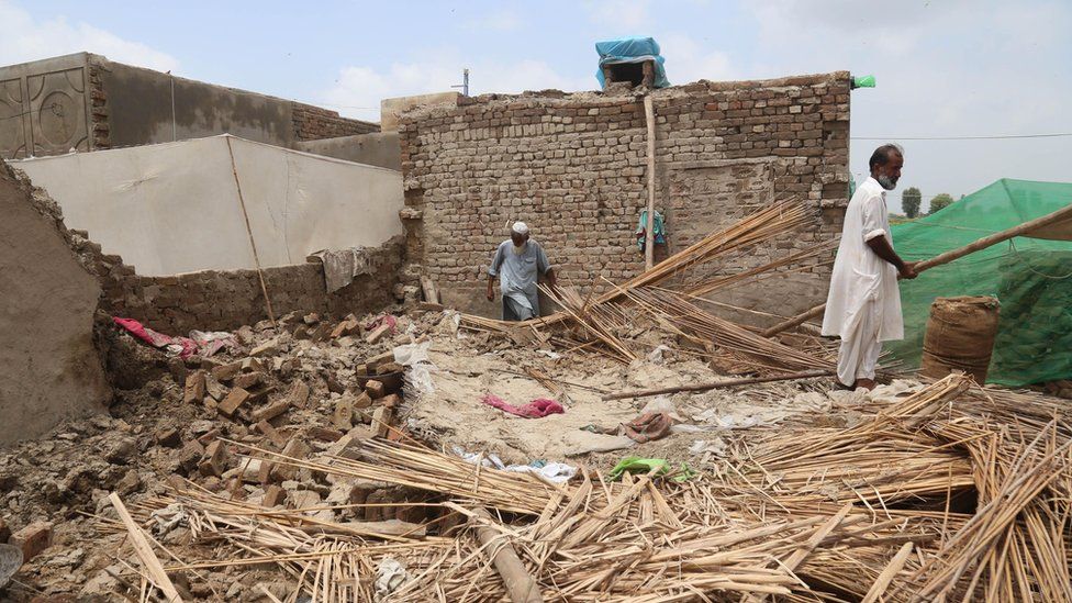 People check the damage to their houses in the aftermath of floods in Sanghar District, Sindh province, Pakistan, 29 August 2022.