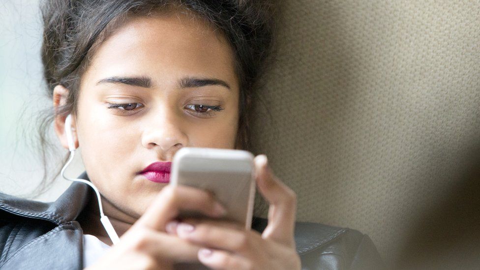 Teenage girl looking at phone