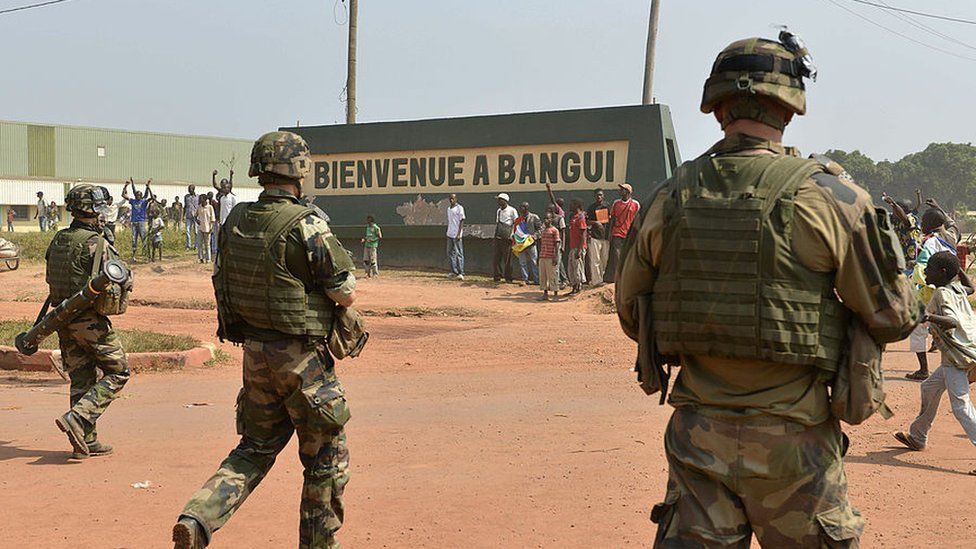 French soldiers patrol in the streets of the Combattant neighborhood in Bangui on December 20, 2013, as part of operation Sangaris.