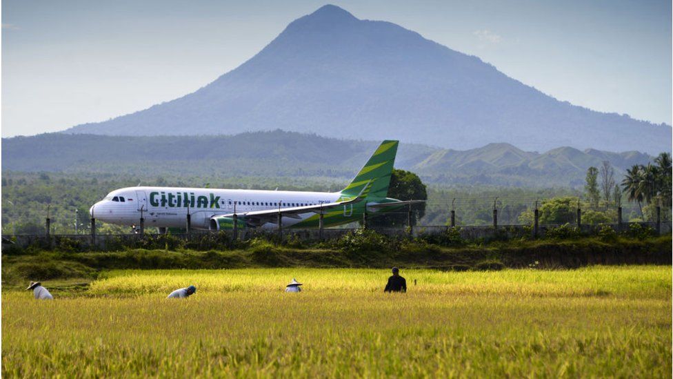 A plane taking off from an airport in Indonesia