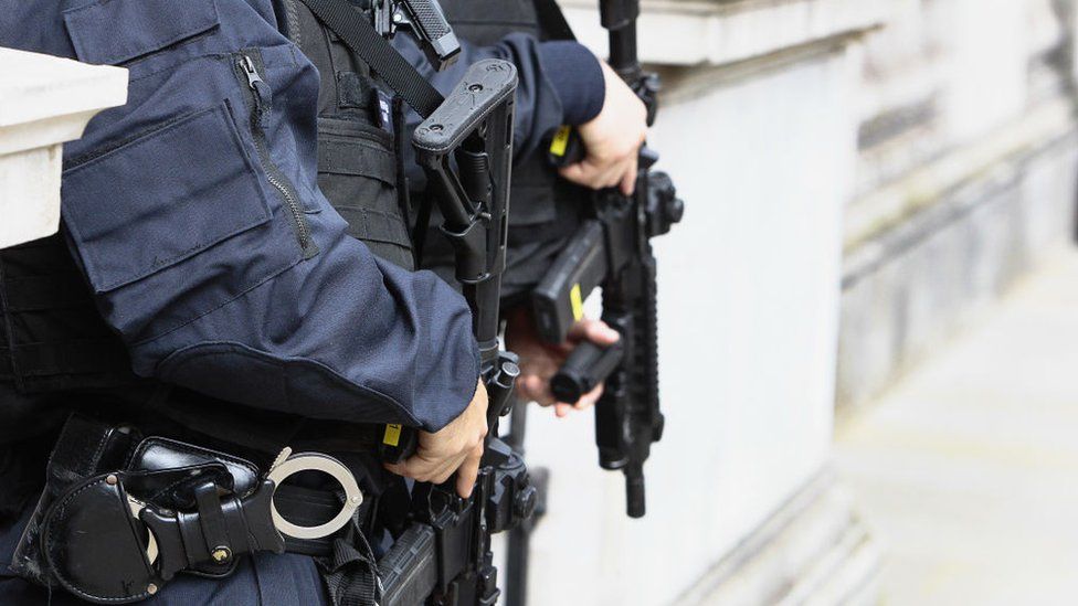 Police officers carrying firearms