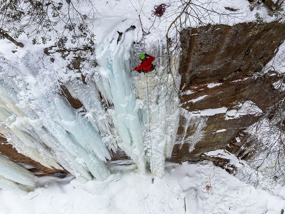 A climber navigates an ice-covered rock wall at the Sandstone Ice Climbing Festival at Robinson Park in Sandstone, Minnesota, US on 8 January 2022