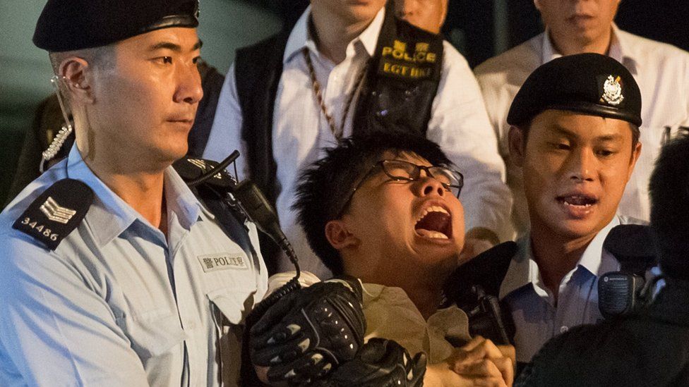 Demosisto secretary general Joshua Wong is arrested by police after climbing on the Golden Bauhinia statue during a protest in Golden Bauhinia Square in Hong Kong, China, 28 June 2017