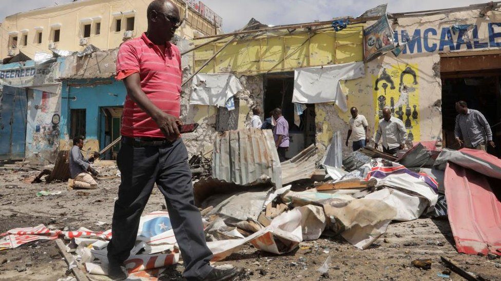 Residents look at the scene of an al Qaeda-linked al Shabaab group militant attack, in Mogadishu, Somalia