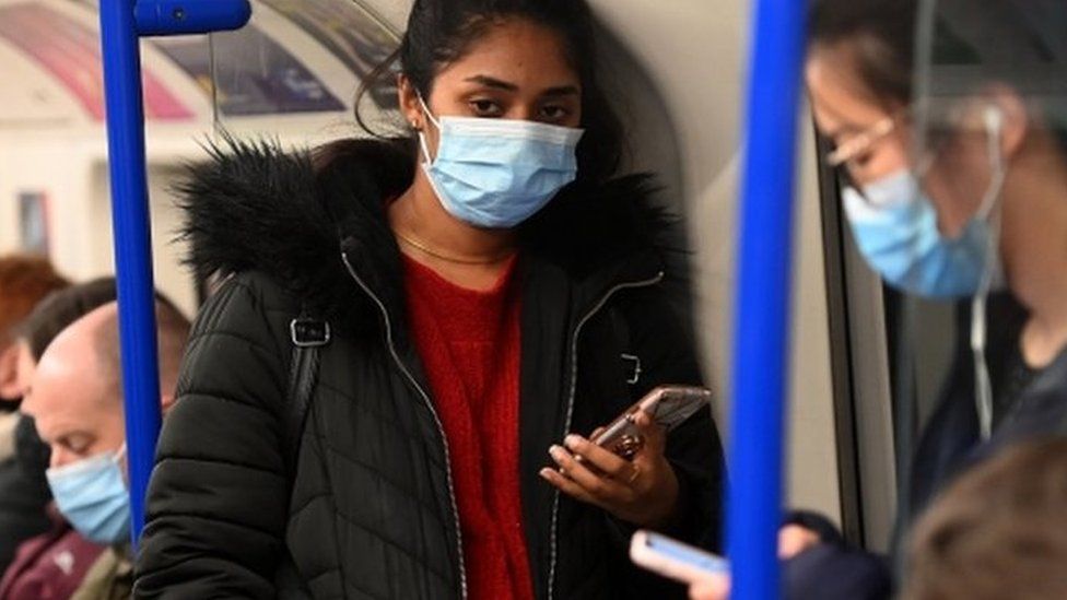 Woman wearing mask on the Tube