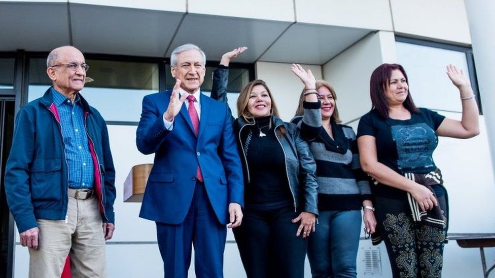 Chile"s Foreign Minister Heraldo Munoz (2nd L) wave to the media next to Venezuela"s Supreme Court justices Jose Nunez (L), Elenis Rodriguez (3rd L), Zuleima Gonzalez (2nd R) and Beatriz Ruiz after they left the country and arrived to Chile for asylum, in Santiago, Chile October 19, 2017.