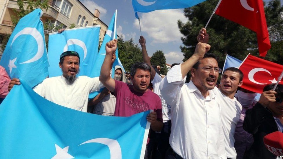 Uighurs living in Turkey and Turkish supporters, some carrying flags of Turkey and East Turkestan, the term separatist Uighurs and Turks use to refer to the Uighurs homeland in China"s Xinjiang region, shout slogan to denounce Chinese rule before the riot police used pepper spray to push back a group of Uighur protesters who try to break through a barricade outside the Chinese Embassy in Ankara, Turkey, Thursday, 9 June 2015.