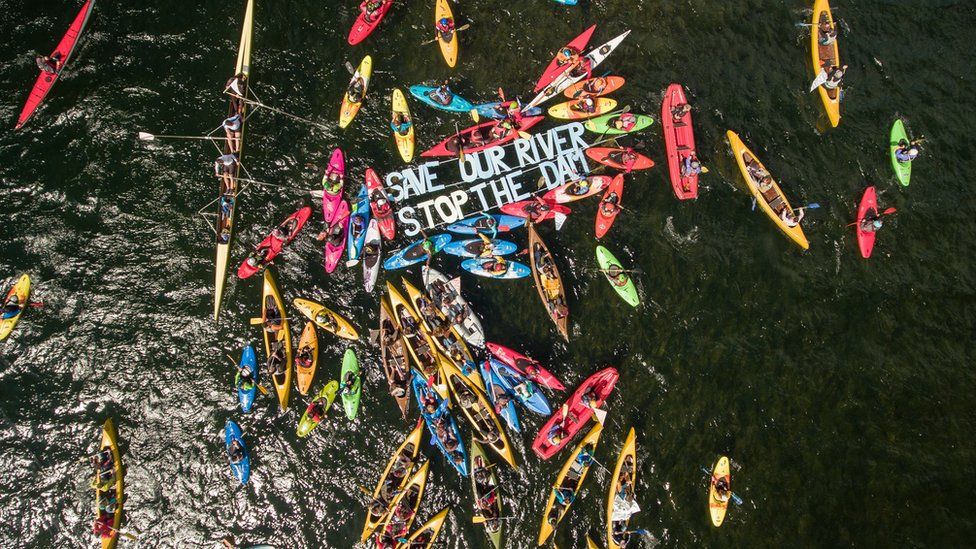 Aerial photo of kayakers protesting the dam