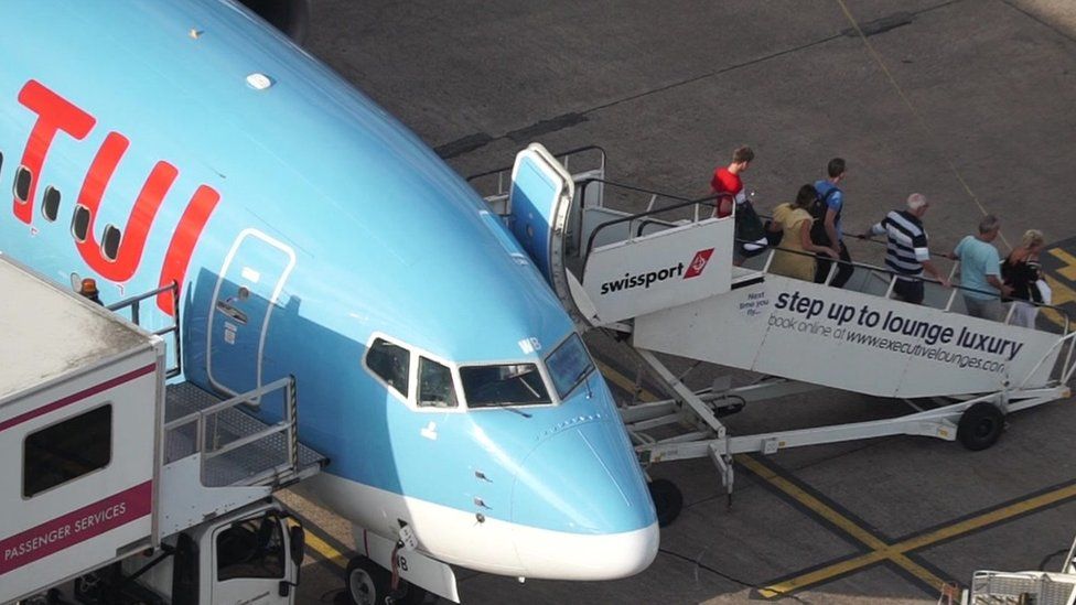Passengers disembark a Tui plane at Manchester