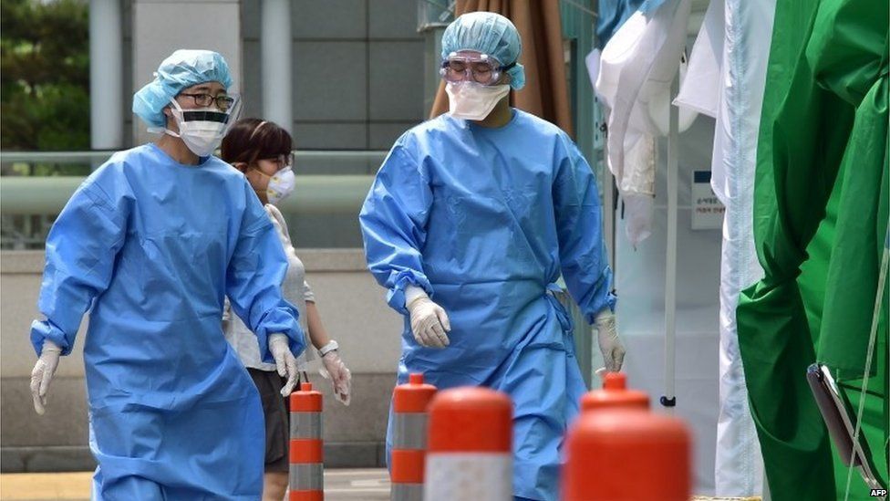 Medical workers in protective gear at a hospital in Seoul, South Korea (24 June 2015)