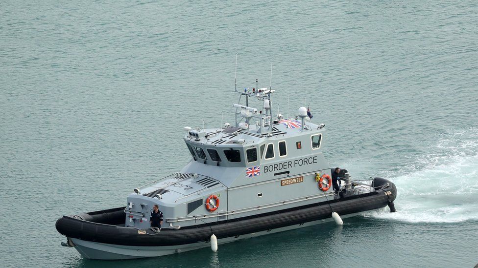 Nine men have been detained after being found in a small boat