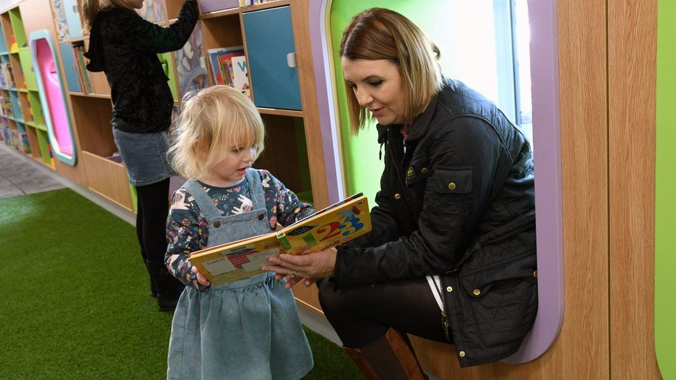 Woman reads with child