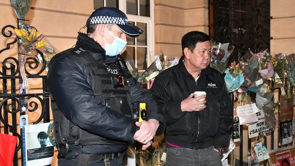 Myanmar ambassador to UK Kyaw Zwar Minn speaks to police officer outside Myanmar's embassy in Mayfair, London