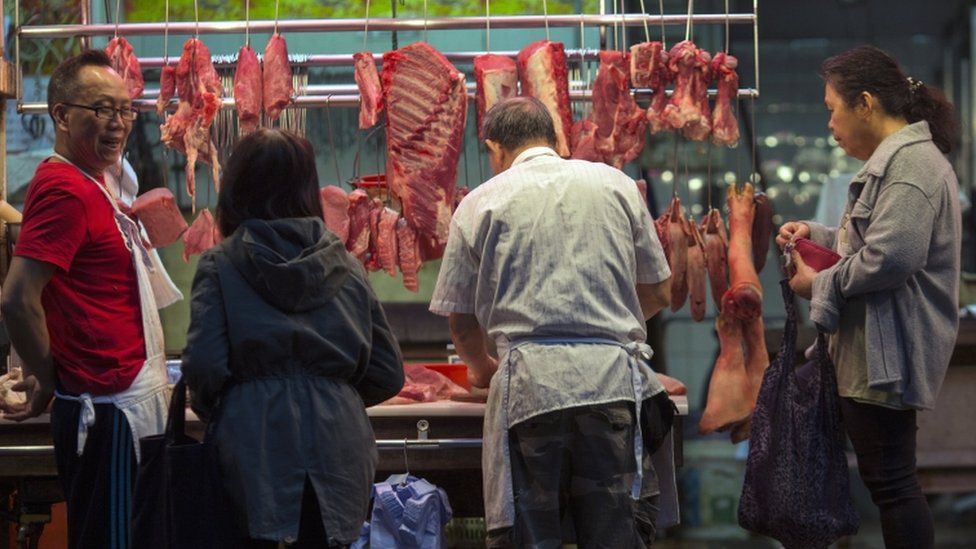 Patrons buy meat from a butcher stall in Hong Kong, China, 22 March 2017.