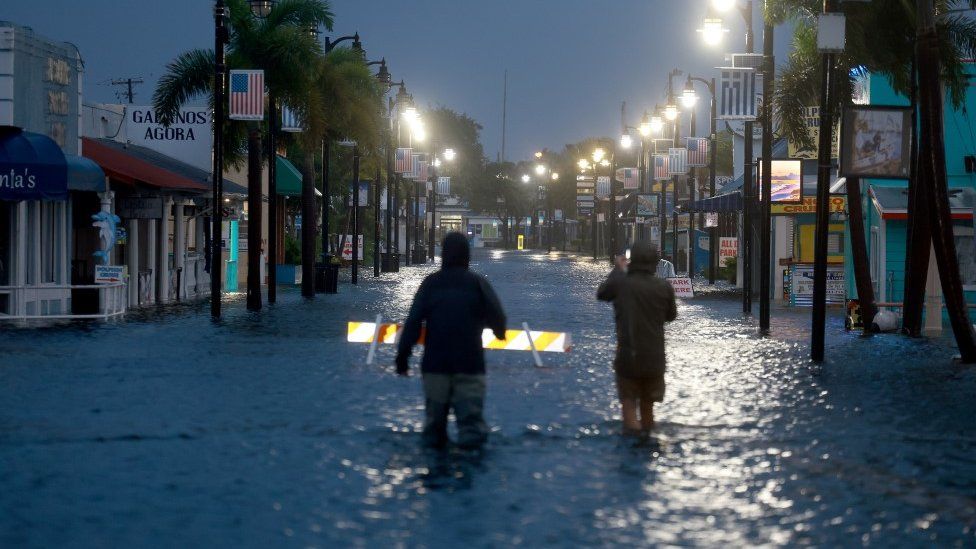 Reporters in flood waters in Tarpon Springs, Florida