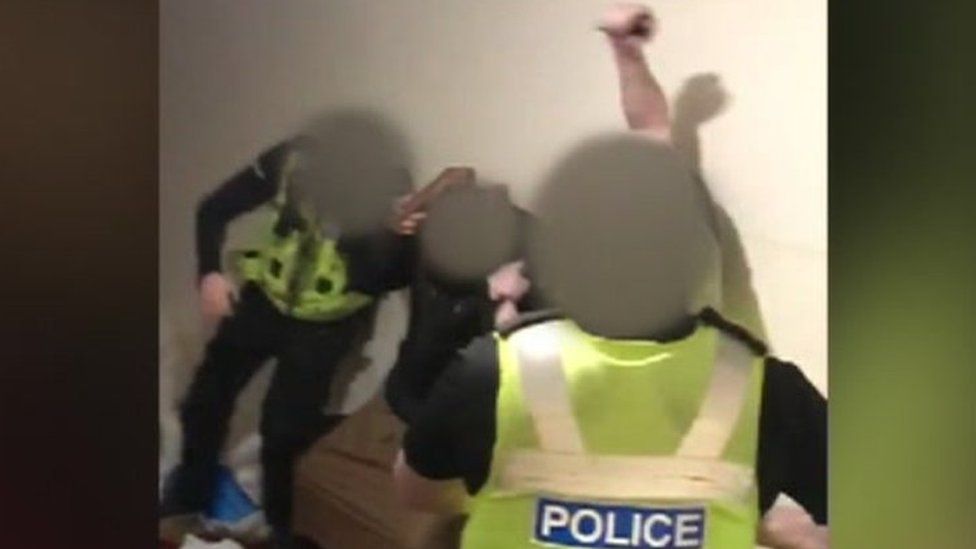 Still from the footage which appears to show police officers violently restraining a man