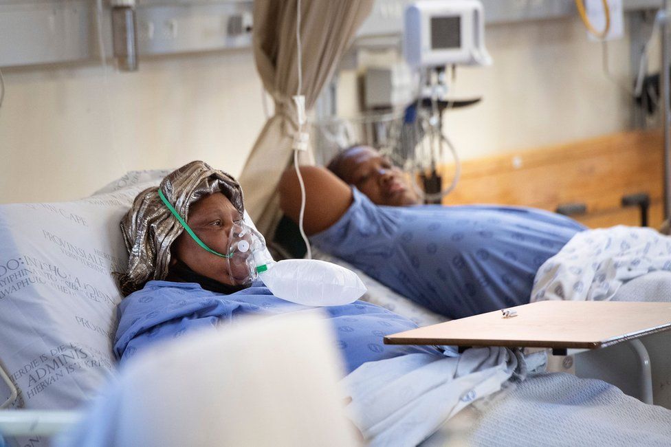 Two coronavirus patients breath in oxygen on a ward in Khayelitsha Hospital in December.