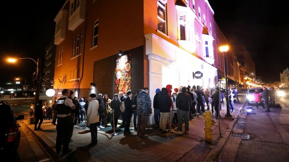 Customers queue outside Tweed, a cannabis shop in St John's Newfoundland, 16 October 2018