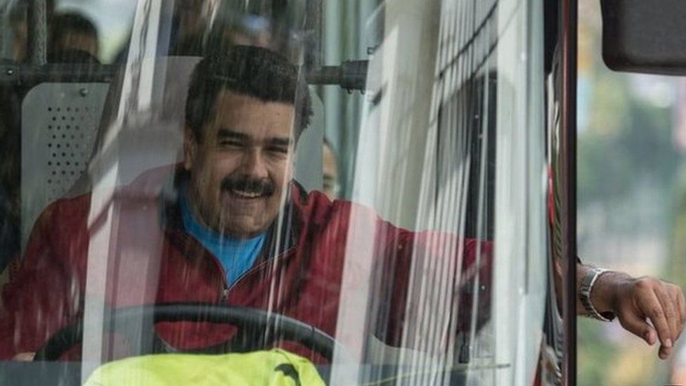 Venezuelan President Nicolas Maduro drives a bus while leaving the airport after arriving in Caracas on 17 January, 2015