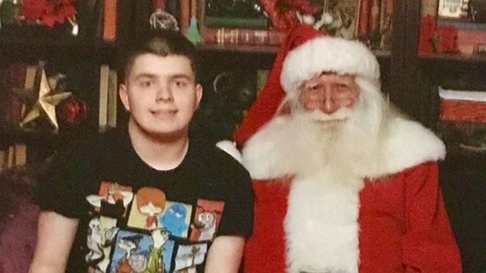 Jack Arnold sitting next to Santa